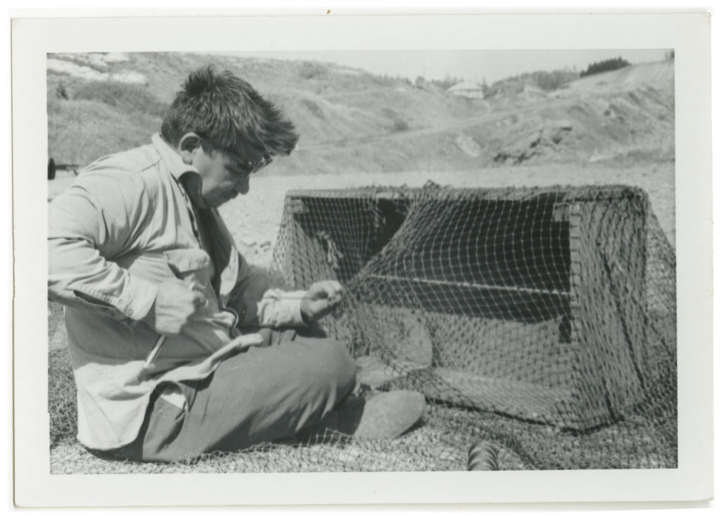 Butch Christofferson from Alaska mending a net.